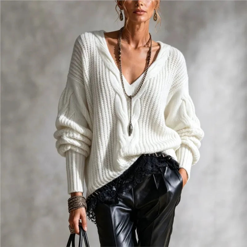 Woman wearing white cable knit V-neck sweater with balloon sleeves
