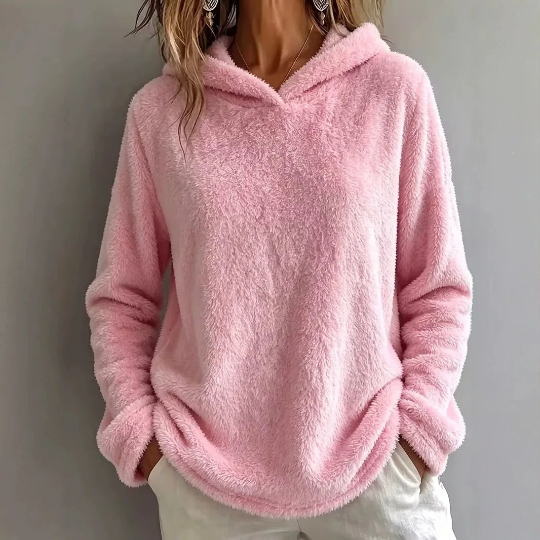 Woman wearing pink fuzzy fleece hooded sweatshirt