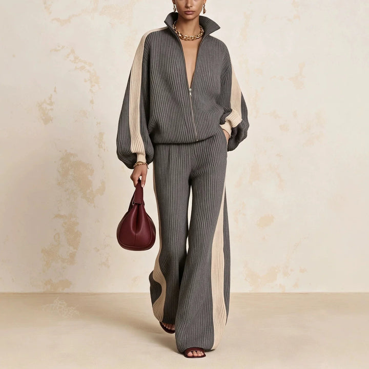 Woman wearing gray color block ribbed knit zip up top and wide leg pants matching set