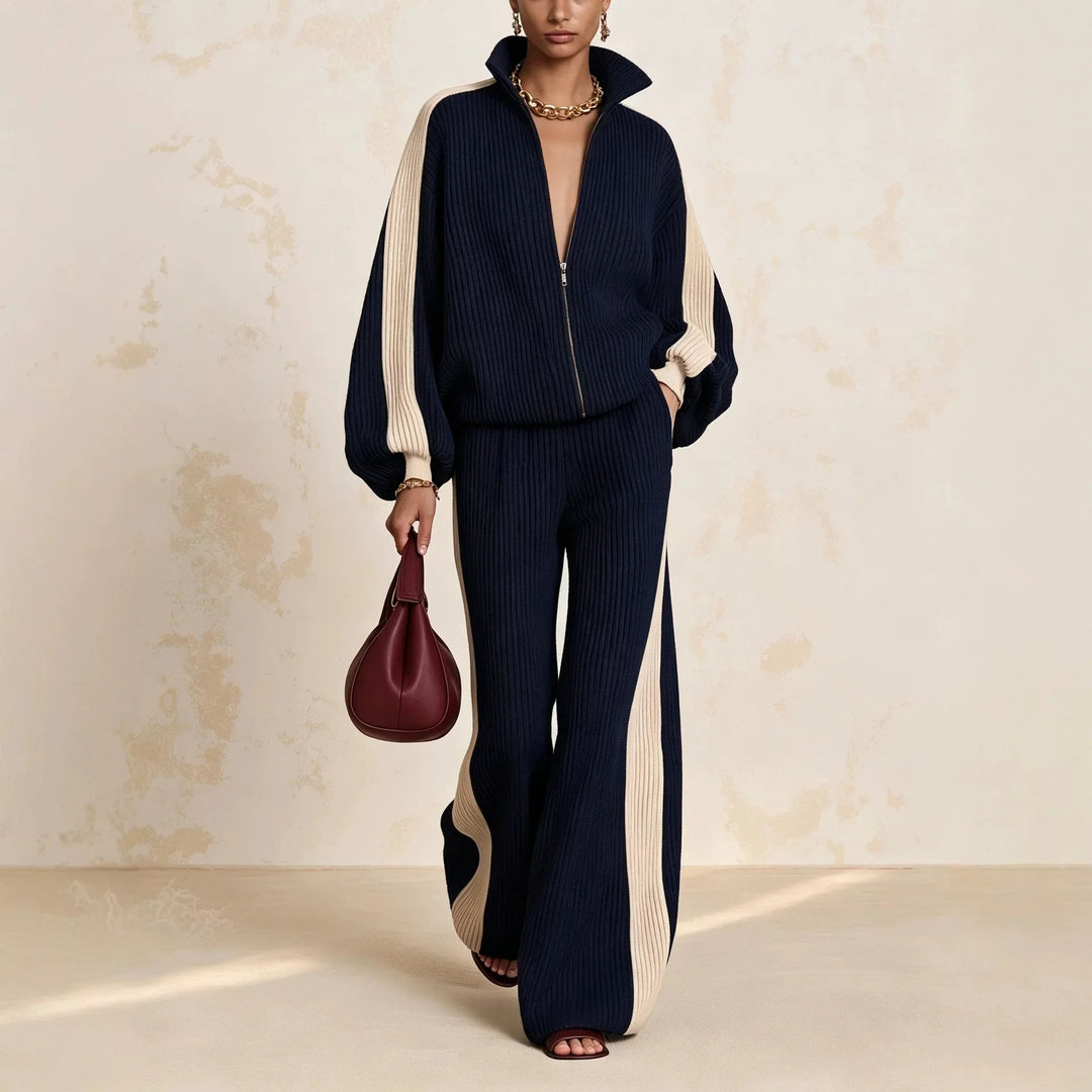 Woman wearing navy color block ribbed knit zip up top and wide leg pants matching set