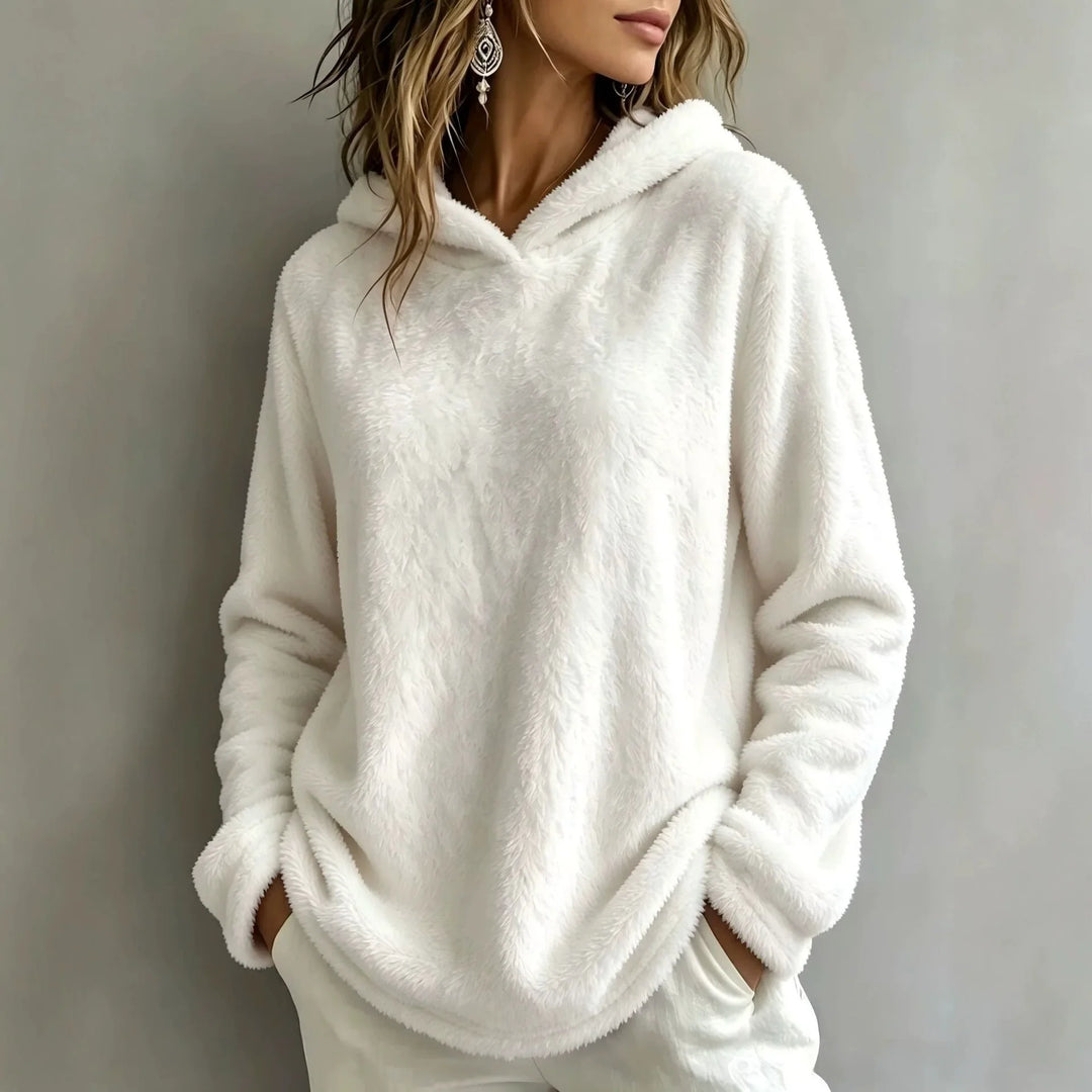 Woman wearing white fuzzy fleece hooded sweatshirt
