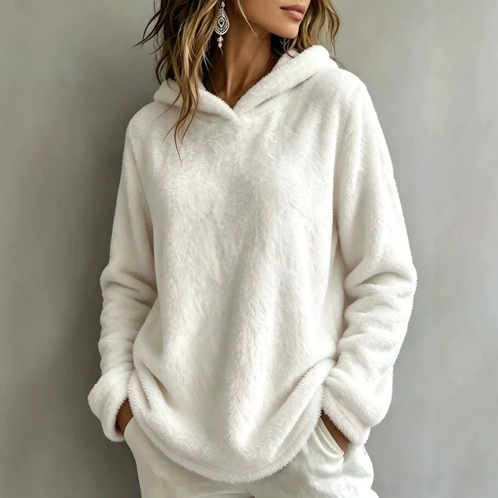 Woman wearing white fuzzy fleece hooded sweatshirt