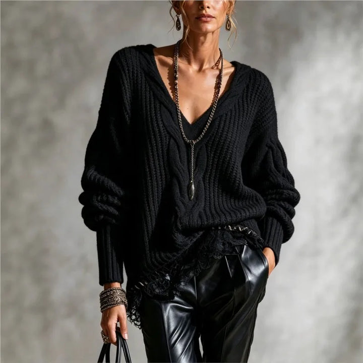 Woman wearing black cable knit V-neck sweater with balloon sleeves