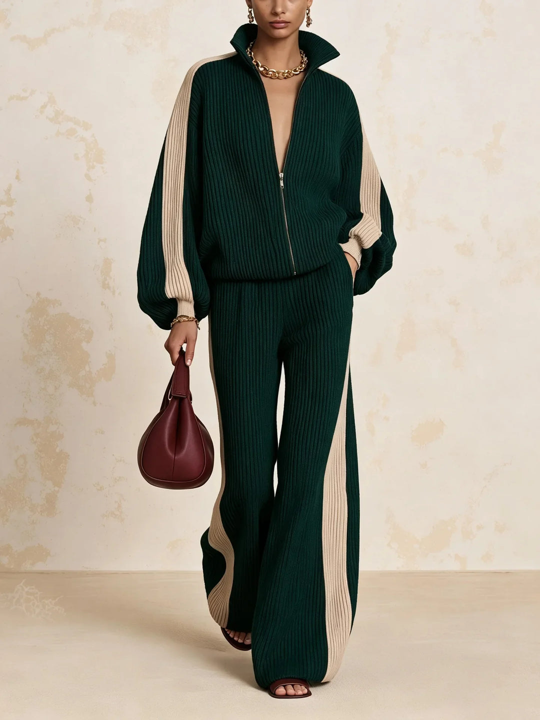 Woman wearing dark green color block ribbed knit zip up top and wide leg pants matching set