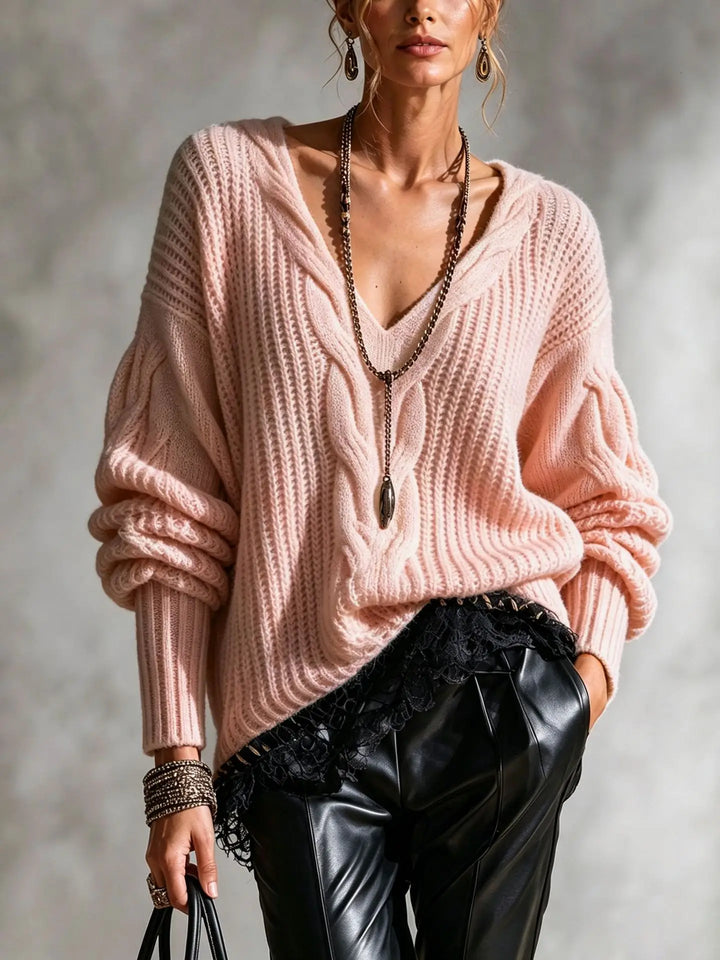 Woman wearing pink cable knit V-neck sweater with balloon sleeves