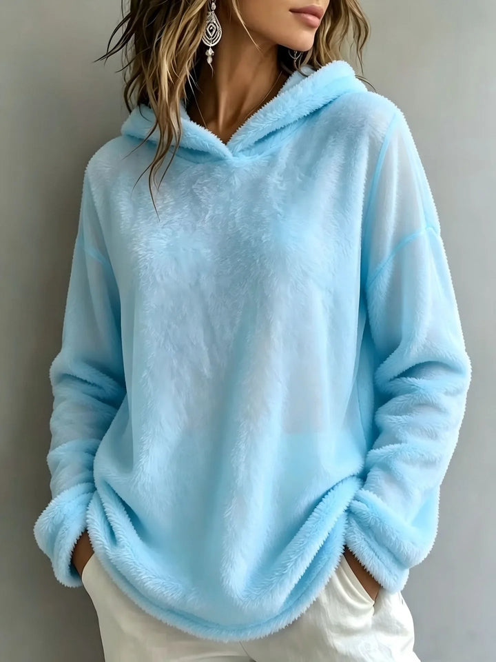 Woman wearing sky blue fuzzy fleece hooded sweatshirt