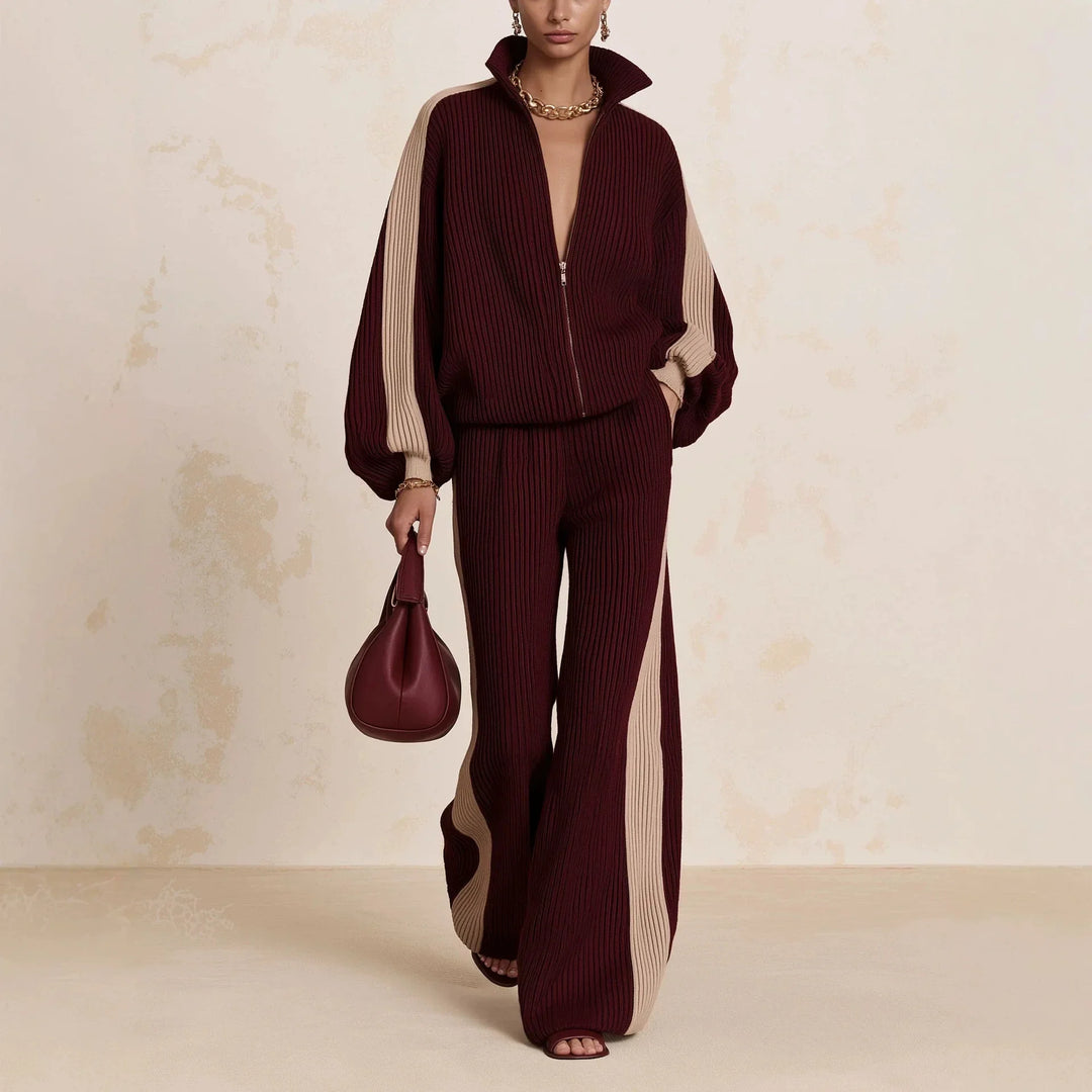 Woman wearing burgundy color block ribbed knit zip up top and wide leg pants matching set